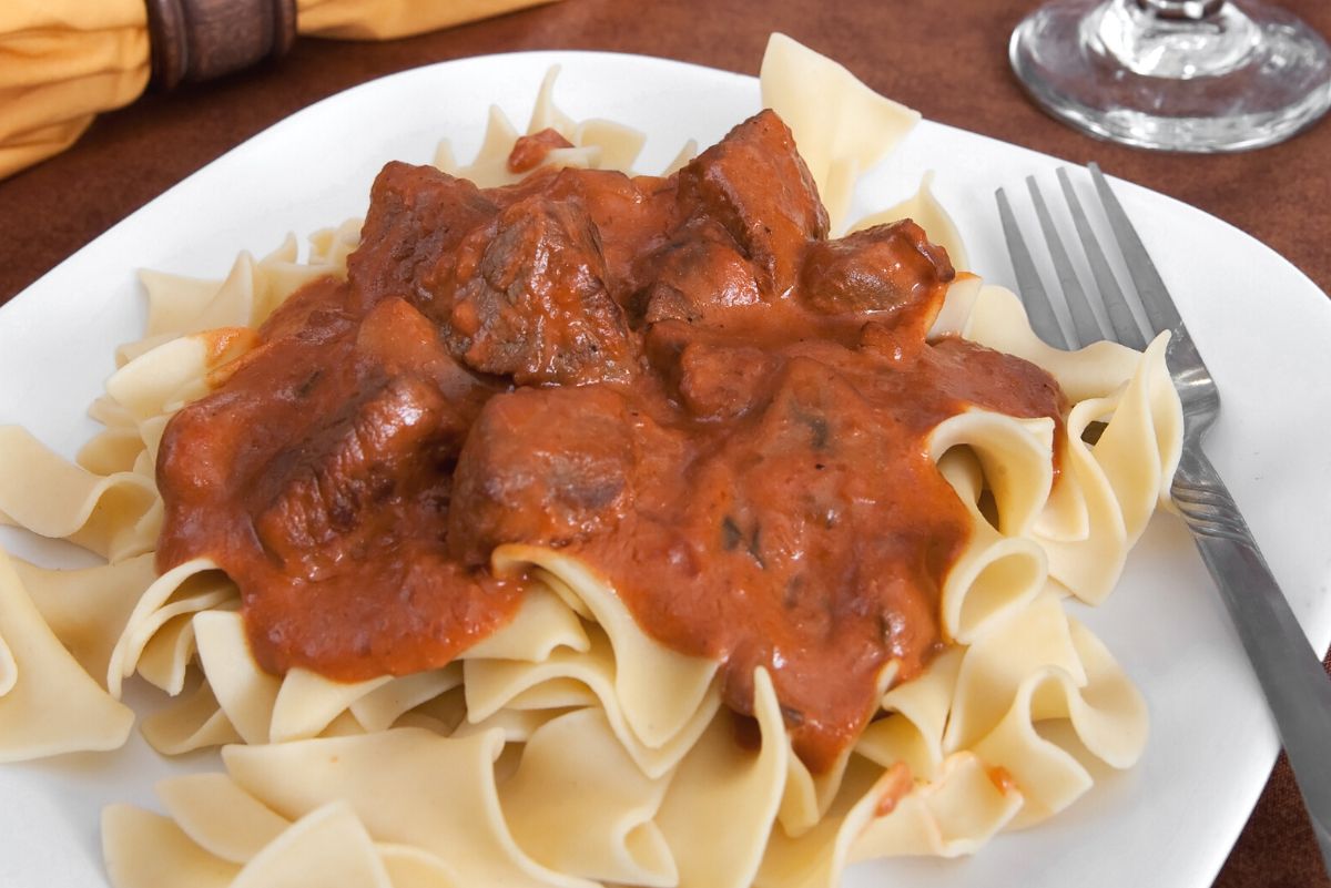 Weight Watchers Beef Stroganoff on a white plate with a fork.