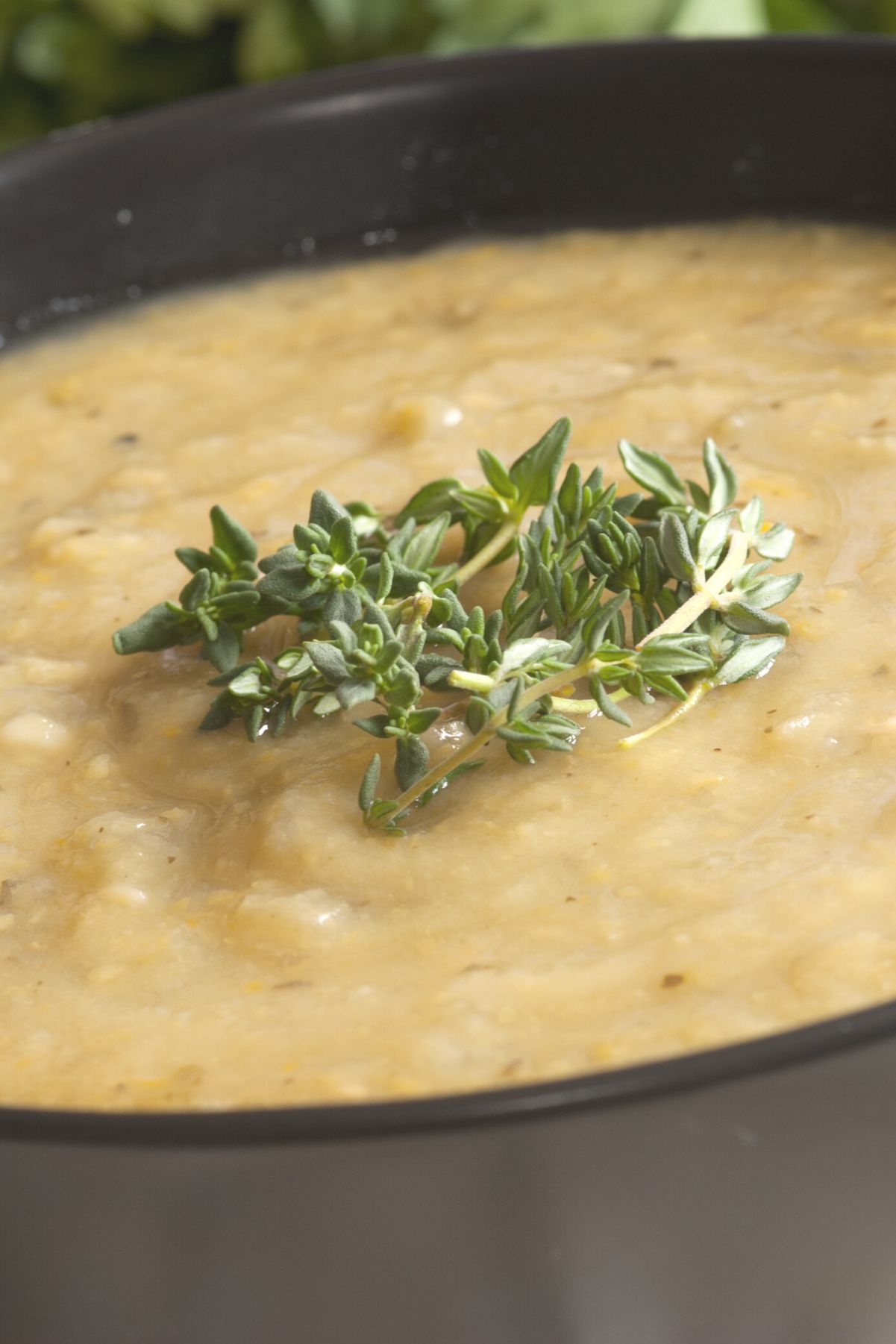 Closeup of Weight Watchers Cauliflower Soup in a black bowl.