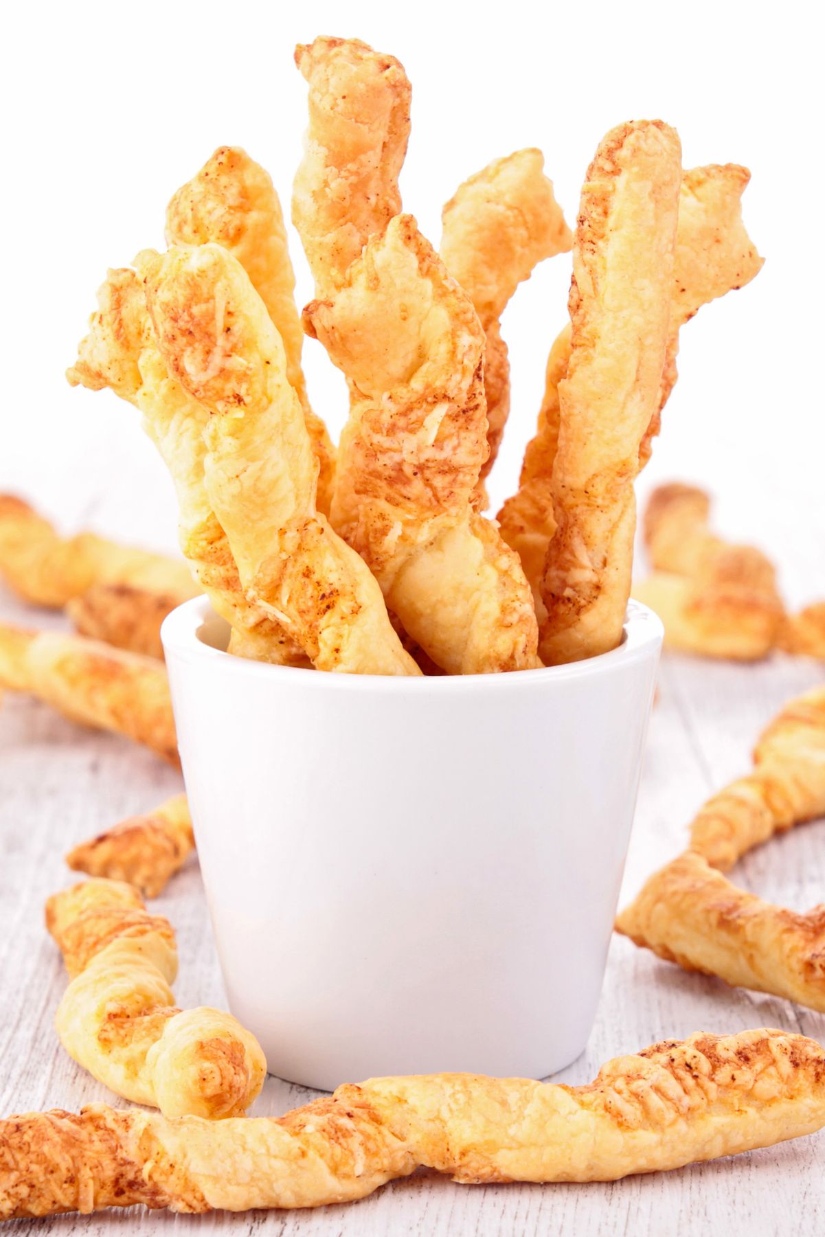 Weight Watchers Crispy and Spicy Cheese Twists in a white cup.