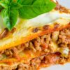 Closeup of Weight Watchers Lasagna with Meat Sauce on a white plate.