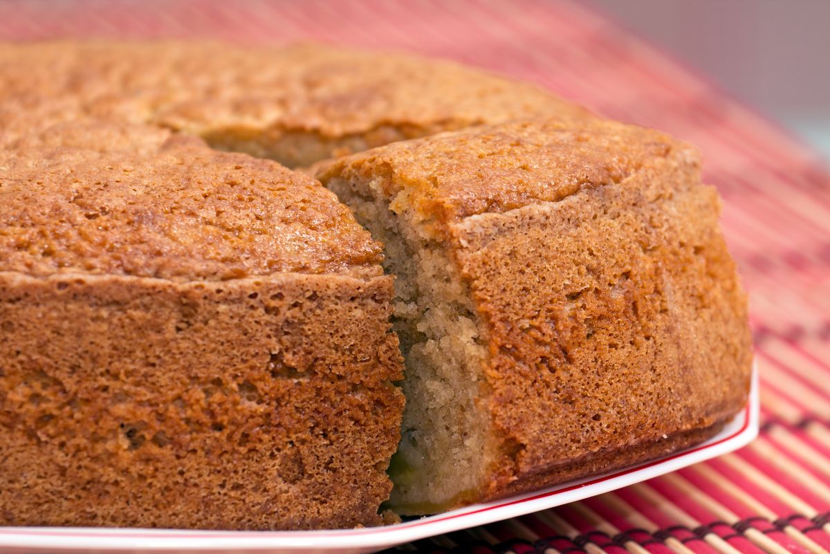 Weight Watchers Apple Swirl Coffee Cake on a white plate sitting on a red and white tablecloth.