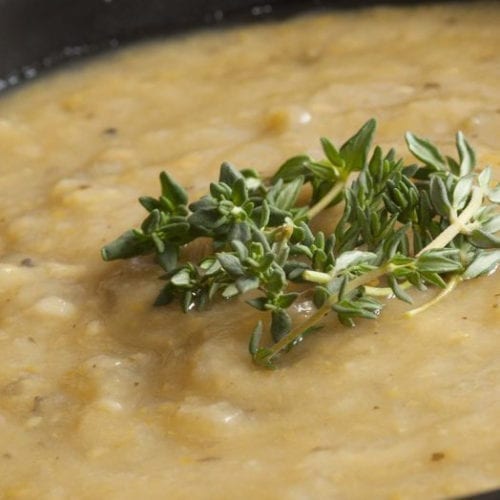 Cauliflower Soup in a black bowl.