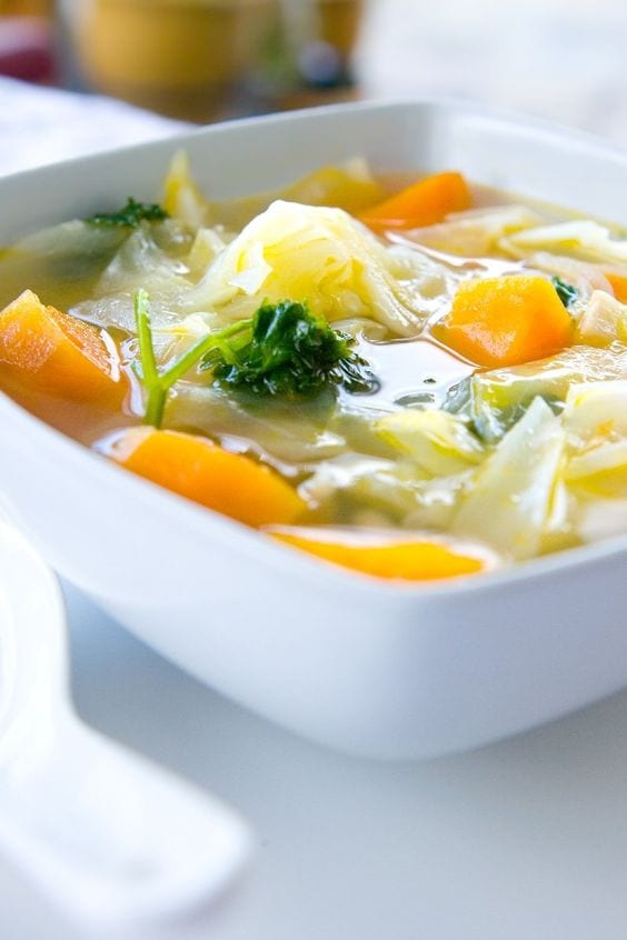 Vegetable soup in a square, white bowl