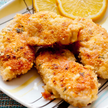 Weight Watchers Parmesan Chicken Recipe on a white plate with an orange slice.