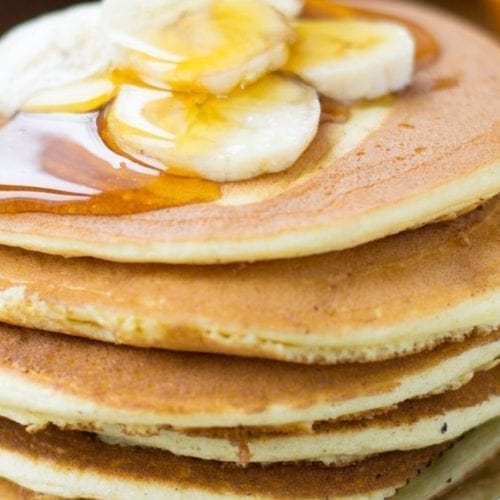 Stack of pancakes topped with bananas