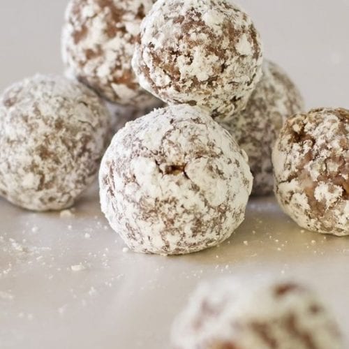 Weight Watchers Chocolate Rum Balls in a pile on a white surface