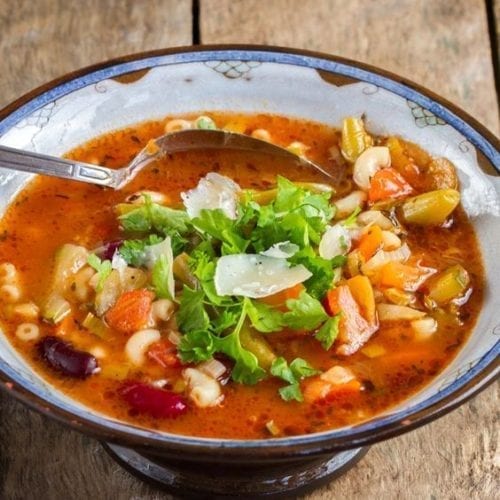 Minestrone in a bowl with a spoon