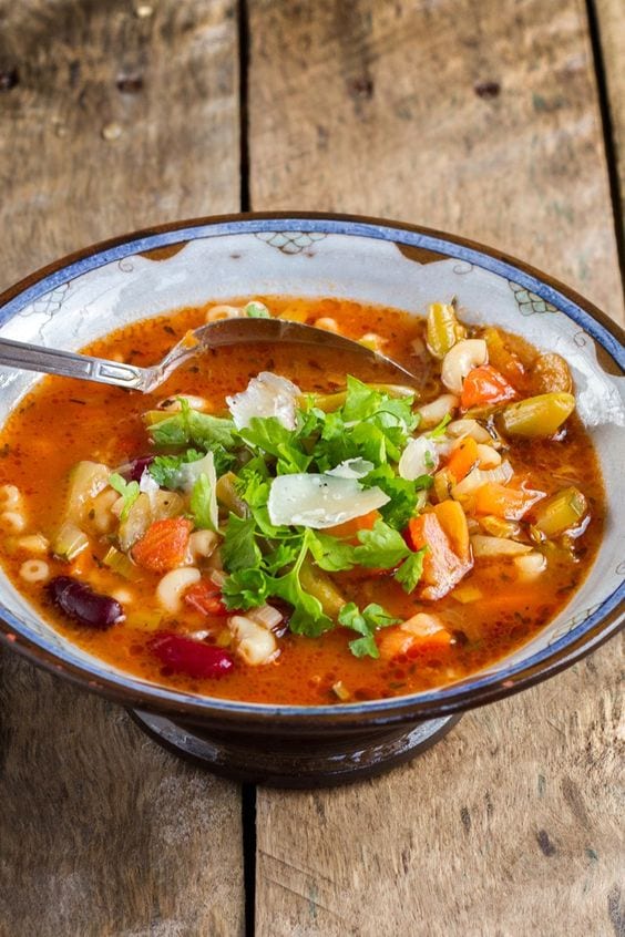 Minestrone in a bowl with a spoon