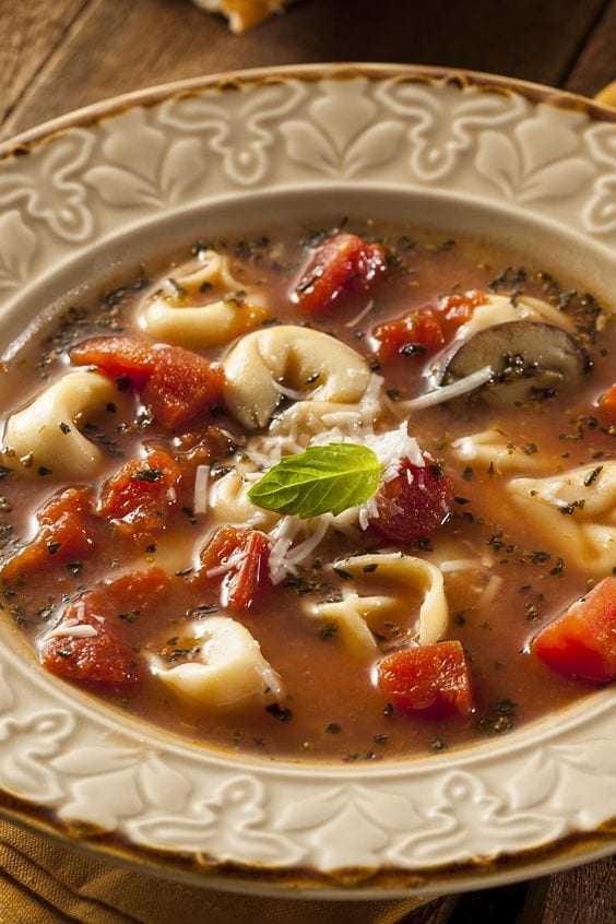 Tortellini Soup in a tan bowl