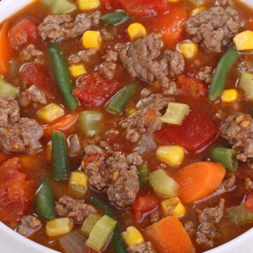 Closeup of Weight Watchers Hamburger Vegetable Soup in a white bowl.