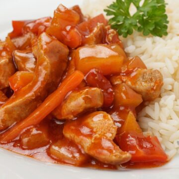 Closeup of Weight Watchers Sweet and Sour Pork on a white plate with rice.