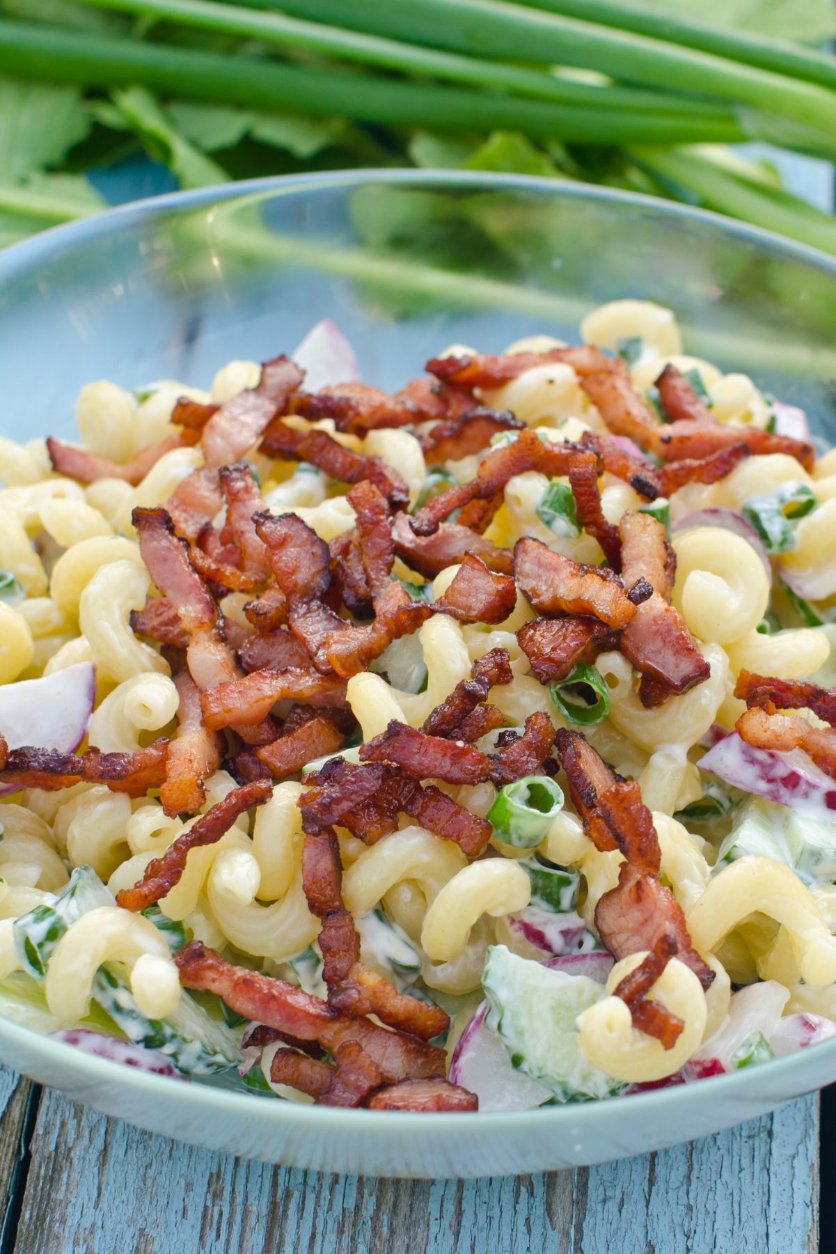 Closeup of Weight Watchers BLT Pasta Salad in a clear glass bowl.