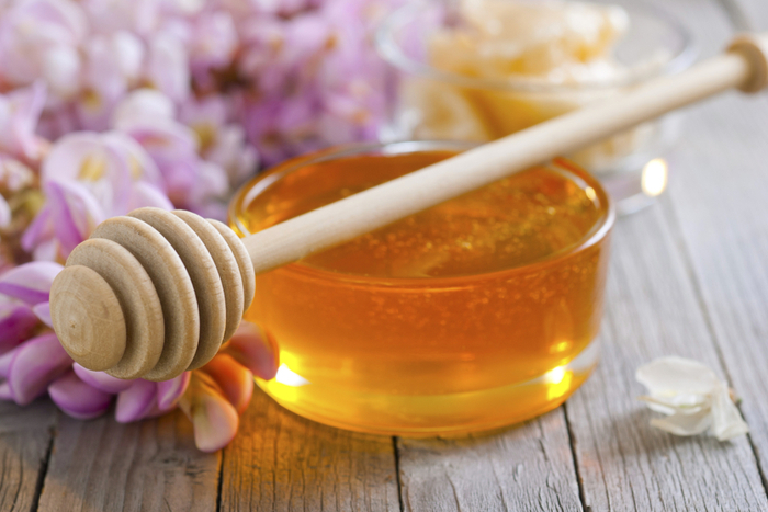 Honey in a clear glass jar.