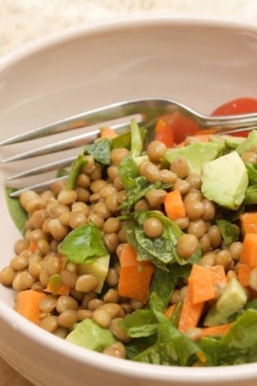 Weight Watchers Mediterranean Lentil Salad in a white bowl with a fork.