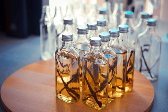 Bottles of Homemade Vanilla Extract on a table.
