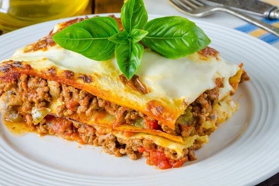 Weight Watchers Lasagna with meat sauce on a white plate.