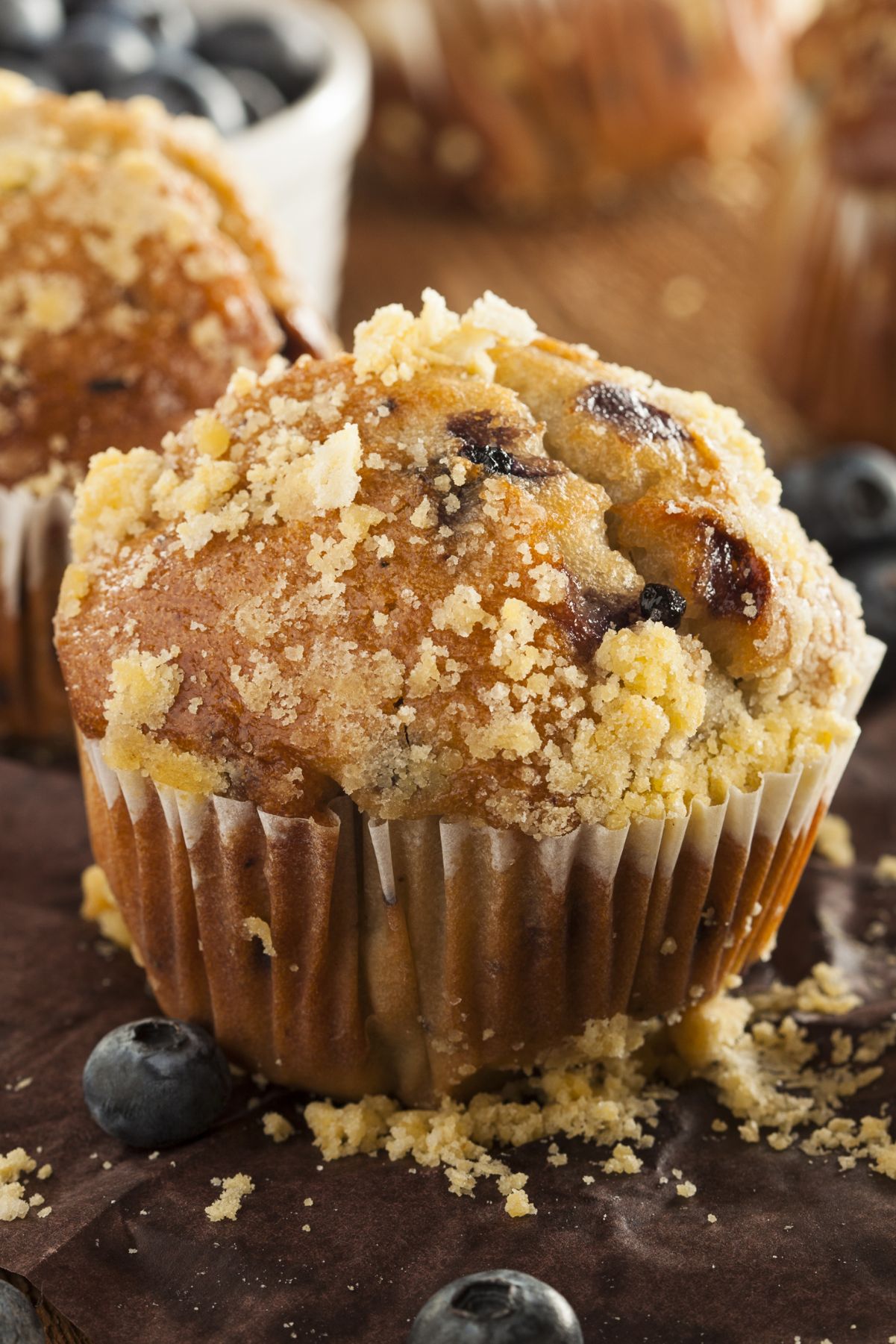 Closeup of Weight Watchers Blueberry Streusel Muffins on a wooden surface.