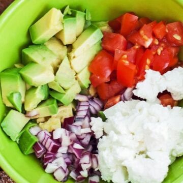 Ingredients for Weight Watchers Avocado Feta Salsa in a green bowl
