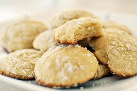 A pile of lemon cookies on a white plate.