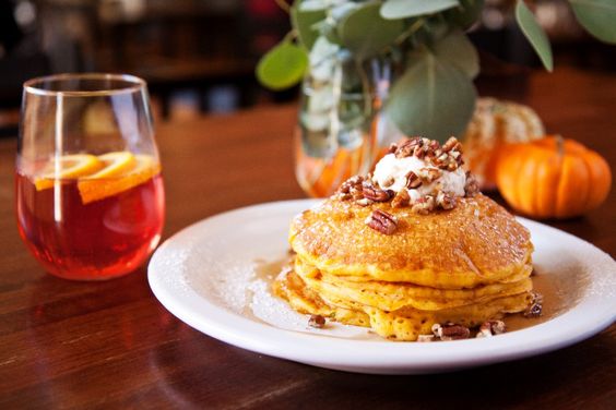 A stack of Weight Watchers Paleo Pumpkin Pancakes on a white plate.