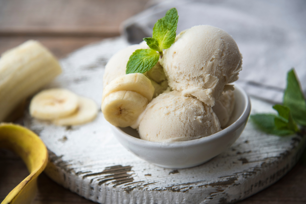 Banana Ice Cream in a white bowl sitting on a white cloth.