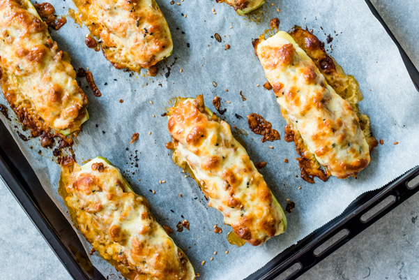 Weight Watchers Cheesy Stuffed Chicken Zucchini on a parchment lined baking sheet.