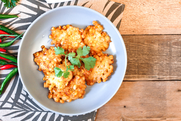 Weight Watchers Skillet Corn Fritters on a white plate, sitting on a wooden table.