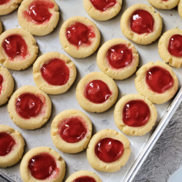 Raspberry Thumbprint Cookies on a baking sheet.