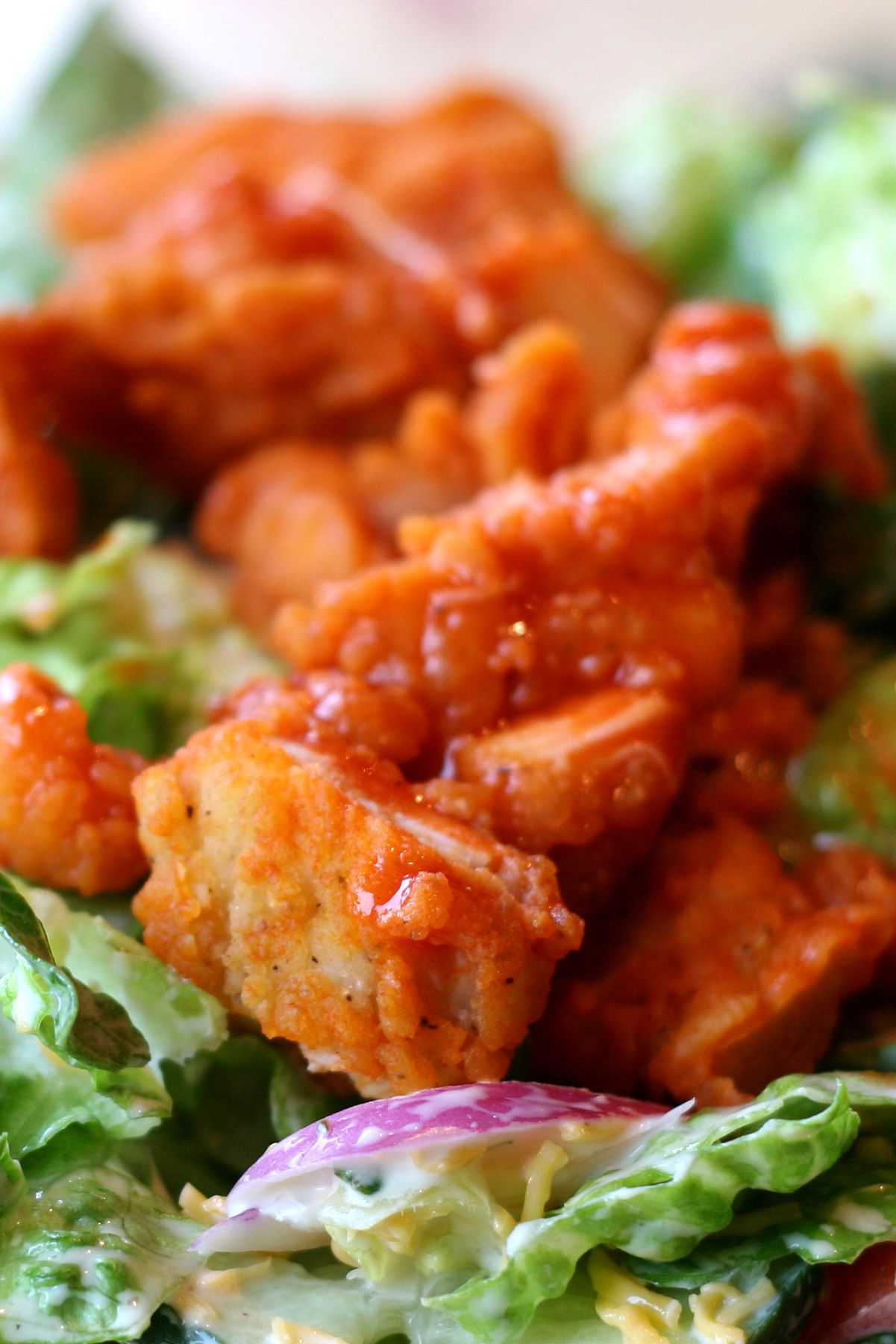 Closeup of Weight Watchers Buffalo Chicken on top of a salad.