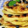 Stack of Weight Watchers Whole Wheat Blueberry Pancakes on a white plate.