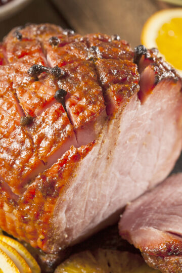Closeup of Weight Watchers Orange and Cranberry Ham with a sliced orange in the background