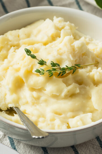 Closeup of Weight Watchers Garlic Sour Cream Mashed Potatoes in a white bowl.