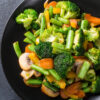 Closeup of Weight Watchers Healthy Vegetable Stir-Fry in a black bowl.