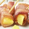 Closeup of Weight Watchers Bacon Wrapped Pineapple with toothpicks in them.