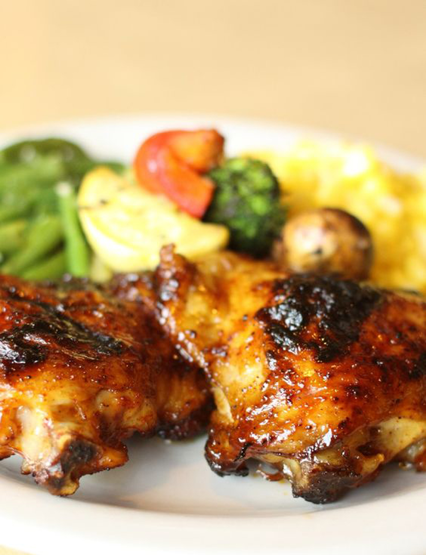 Two pieces of Weight Watchers Key West Chicken on a white plate with vegetables.