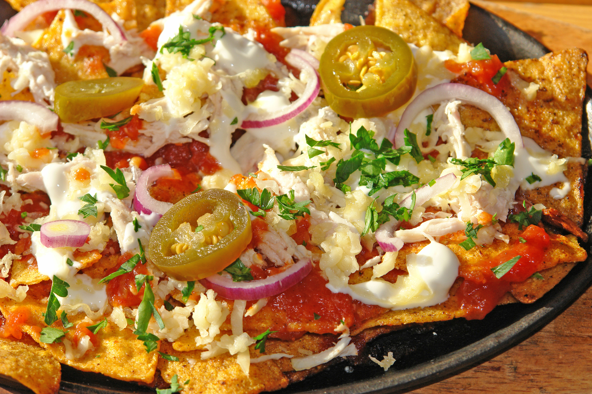 Crockpot Weight Watchers Shredded Chicken Nachos on a black plate