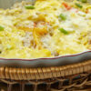 Weight Watchers Mexican Beans and Rice Casserole in a white dish sitting in a wooden basket.