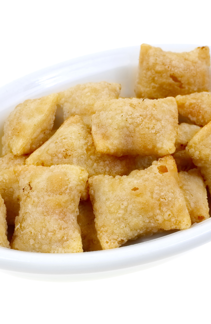 Closeup of Weight Watchers Air Fryer Wonton Pizza Bites in a white bowl, with a white background.