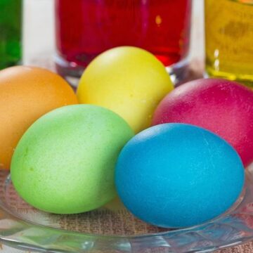 Colored Easter eggs on a glass plate.