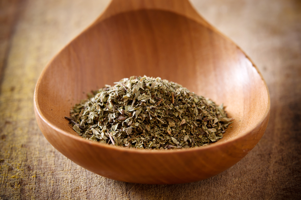 oregano in a wooden spoon.