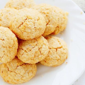 A pile of Simple Weight Watchers Angel Food Cookies on a white plate with a white background.