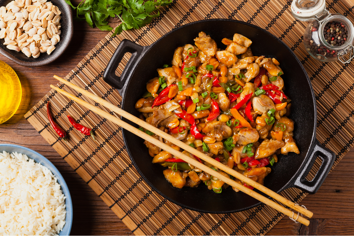Best Weight Watchers Kung Pao Chicken in a black pan with chopsticks on it.