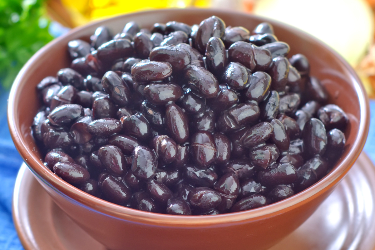 Black beans in a brown bowl.