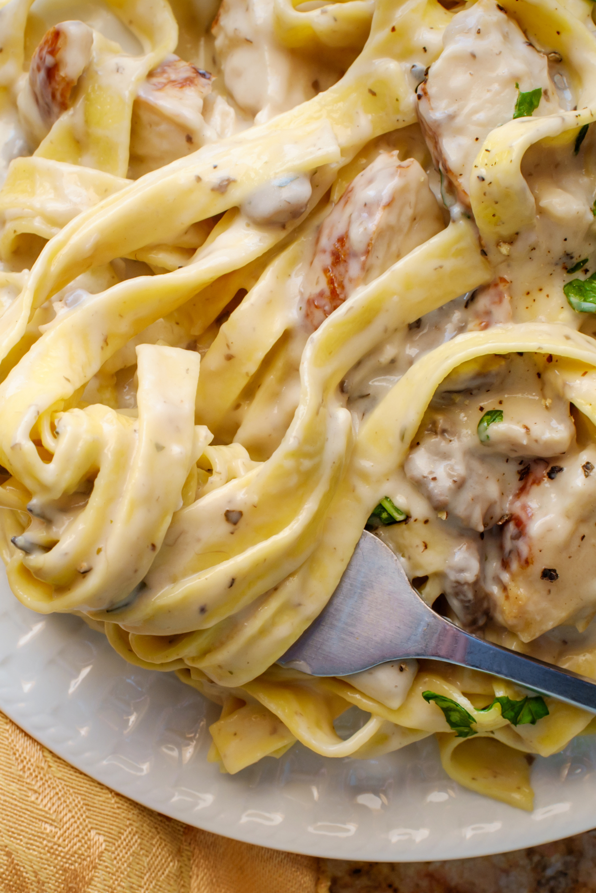 Weight Watchers Chicken Fettuccini Alfredo Recipe on a white plate with a fork on it.