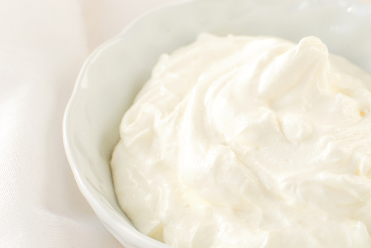 Greek Yogurt in a white bowl with a white background.