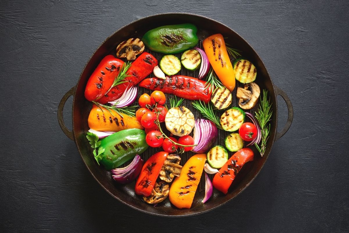 Simple Weight Watchers Grilled Vegetables in a black, round dish on a dark, slate surface.