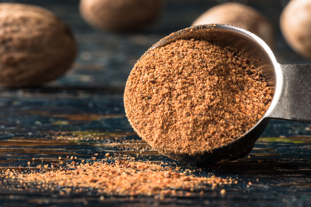 Ground nutmeg in a measuring spoon.