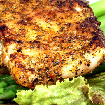 Closeup of Easy Weight Watchers Grilled Sea Bass on a bed of lettuce.