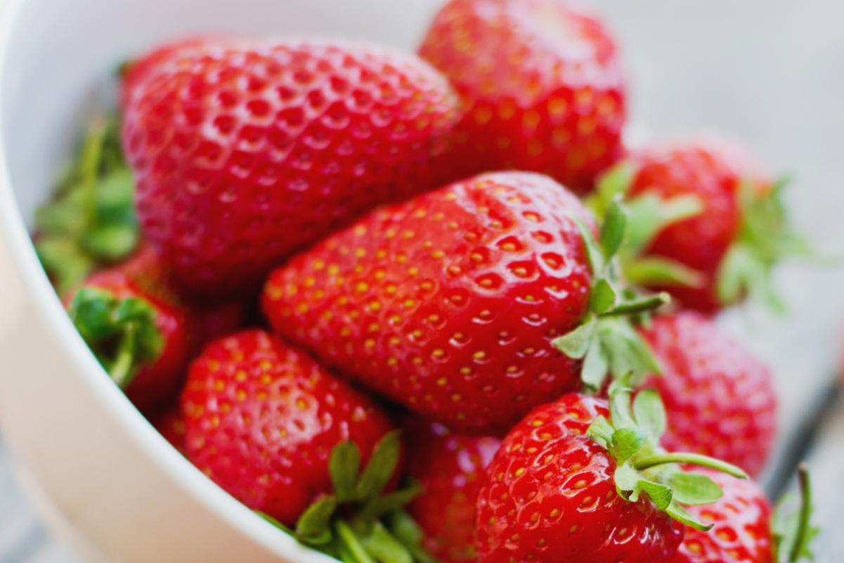 Fresh Strawberries in a white bowl.