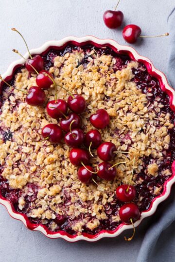 Weight Watchers Cherry and Rhubarb Crumble Dessert in a white pie plate.